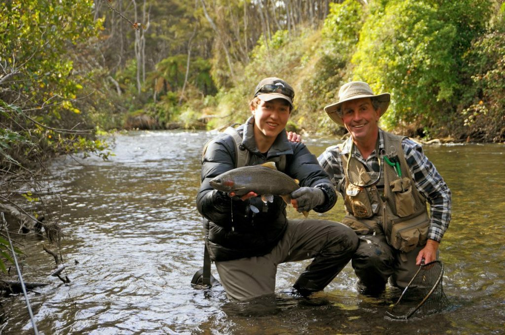 Orvis endorsed fly fishing guide in a river off lake Taupo New Zealand fishing for brown and rainbow trout